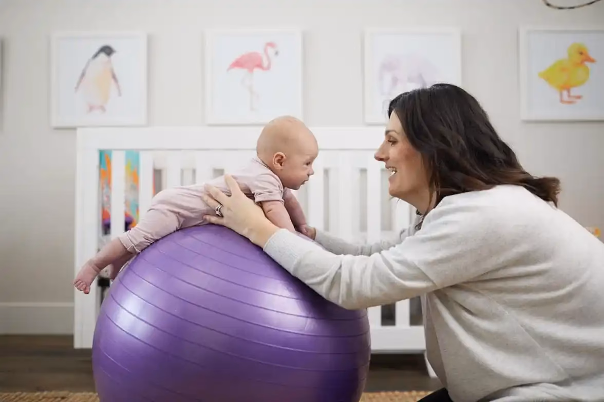 Is it OK to bounce baby on exercise ball?