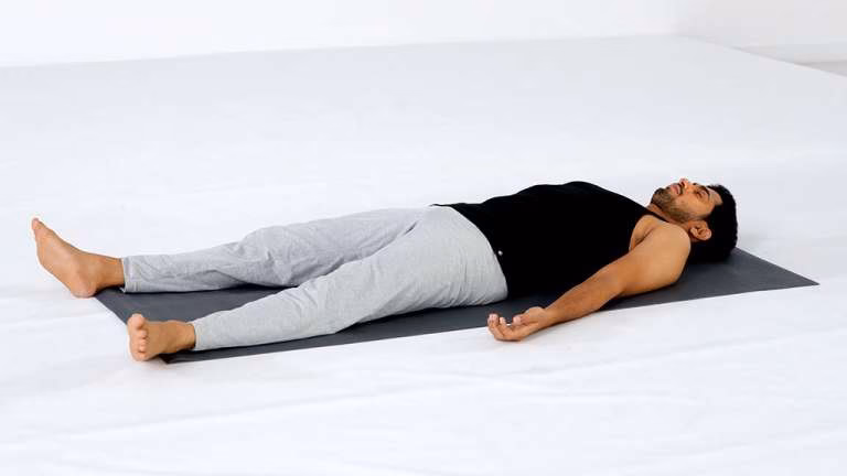 What is the lying down yoga pose called?